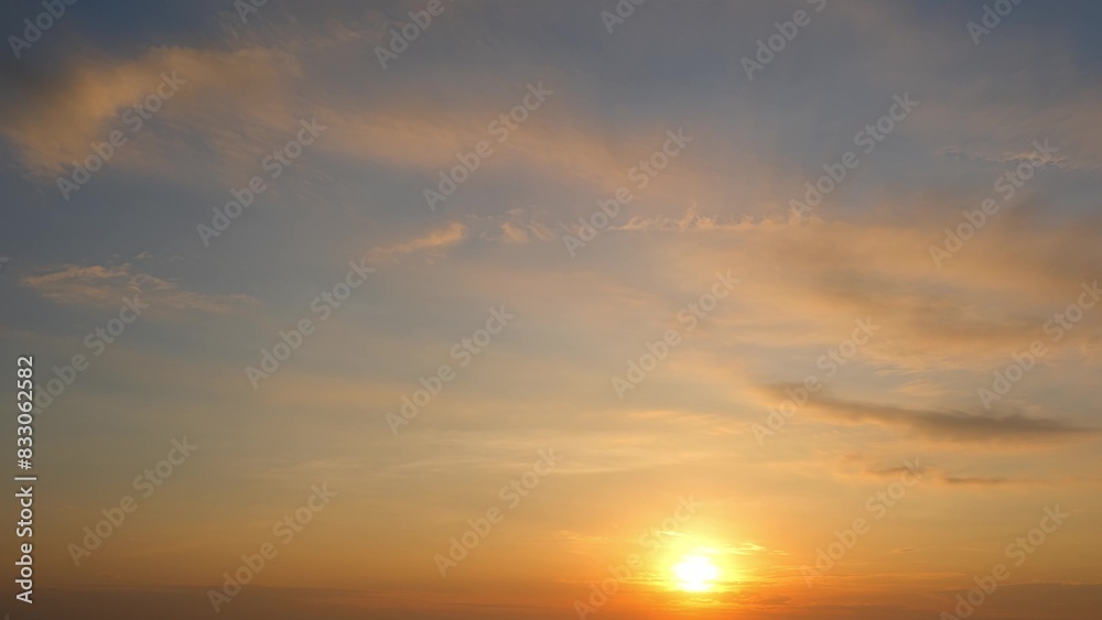 A stunning sunrise with the sun rising above the horizon, casting a golden light across the sky. The clouds are gently illuminated with hues of orange and yellow. Sunrise sky background.
A stunning sunrise with the sun rising above the horizon, casting a golden light across the sky. The clouds are gently illuminated with hues of orange and yellow. Sunrise sky background.