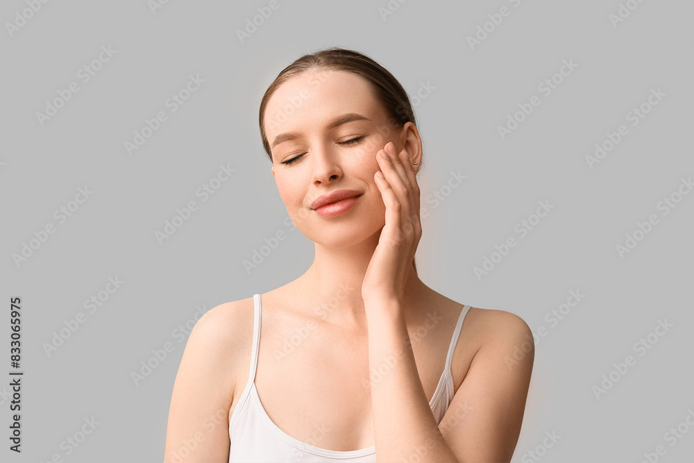 Beautiful young woman with healthy skin on grey background Beautiful young woman with healthy skin on grey background