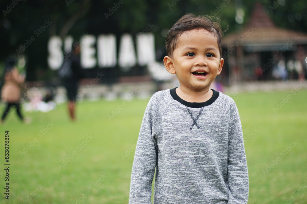 A handsome young boy, nicely dressed showing an expression of joy with hands up in the air looking excited and happy to be playing outdoors.
A handsome young boy, nicely dressed showing an expression of joy with hands up in the air looking excited and happy to be playing outdoors.