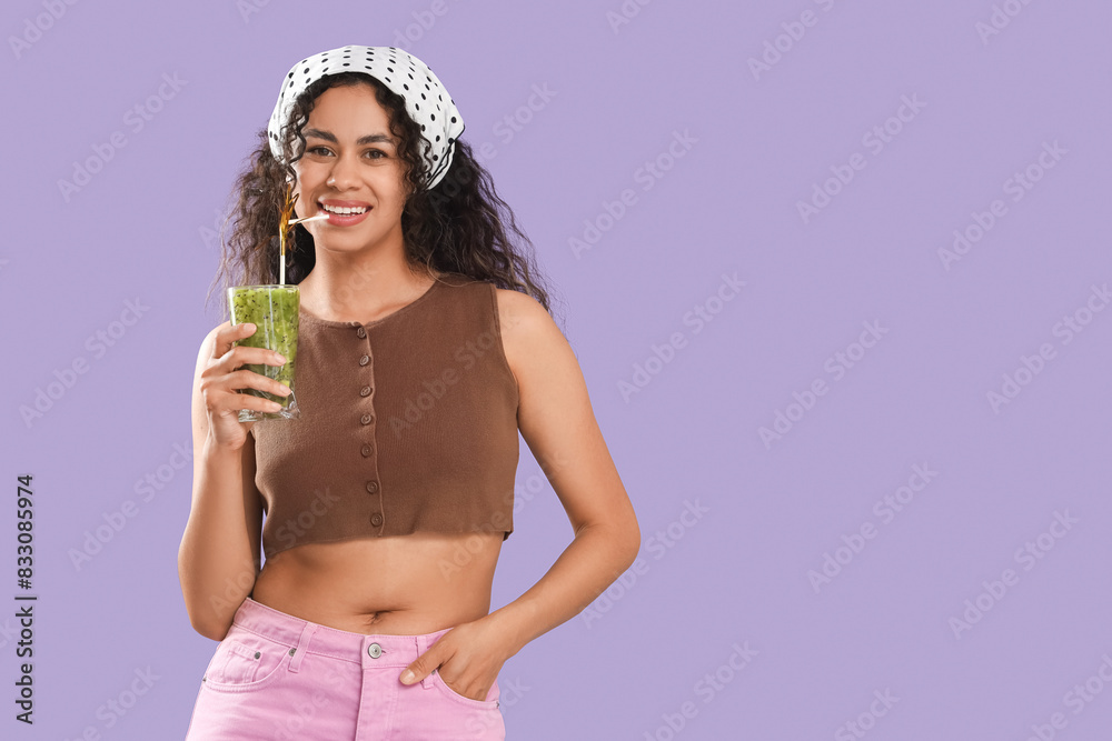 Φωτογραφία Beautiful young happy African-American woman with glass of tasty kiwi smoothie o