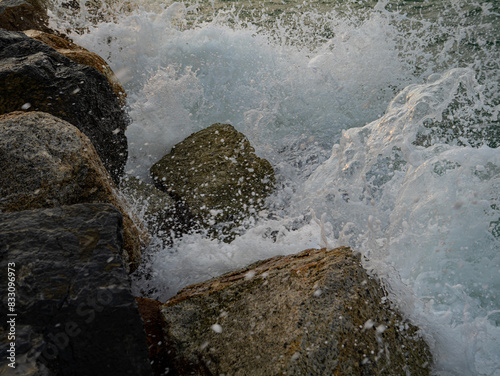 Photos of Close up of the sea waves crashing on the rocks.