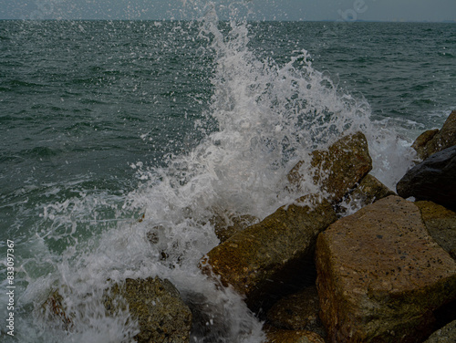 Photos of Close up of the sea waves crashing on the rocks.