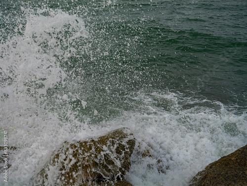 Photos of Close up of the sea waves crashing on the rocks.