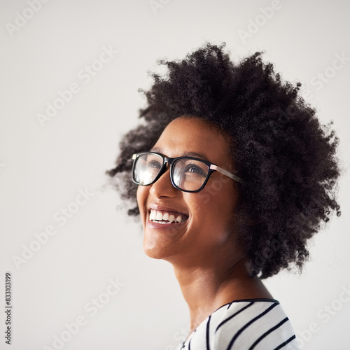 Portrait, African woman and thinking in studio with glasses for idea, fashion and choice. Street wear, gen z and pride for clothes, apparel and smile by white background with style, eyewear and afro