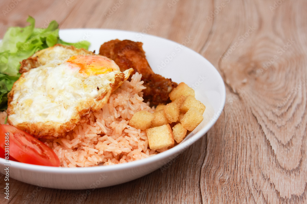 Fried rice with tomato sauce Or as we call it American fried rice Served with fried eggs, fried chicken, fresh stir-fry, and fried bread. Fried rice with tomato sauce Or as we call it American fried rice Served with fried eggs, fried chicken, fresh stir-fry, and fried bread.