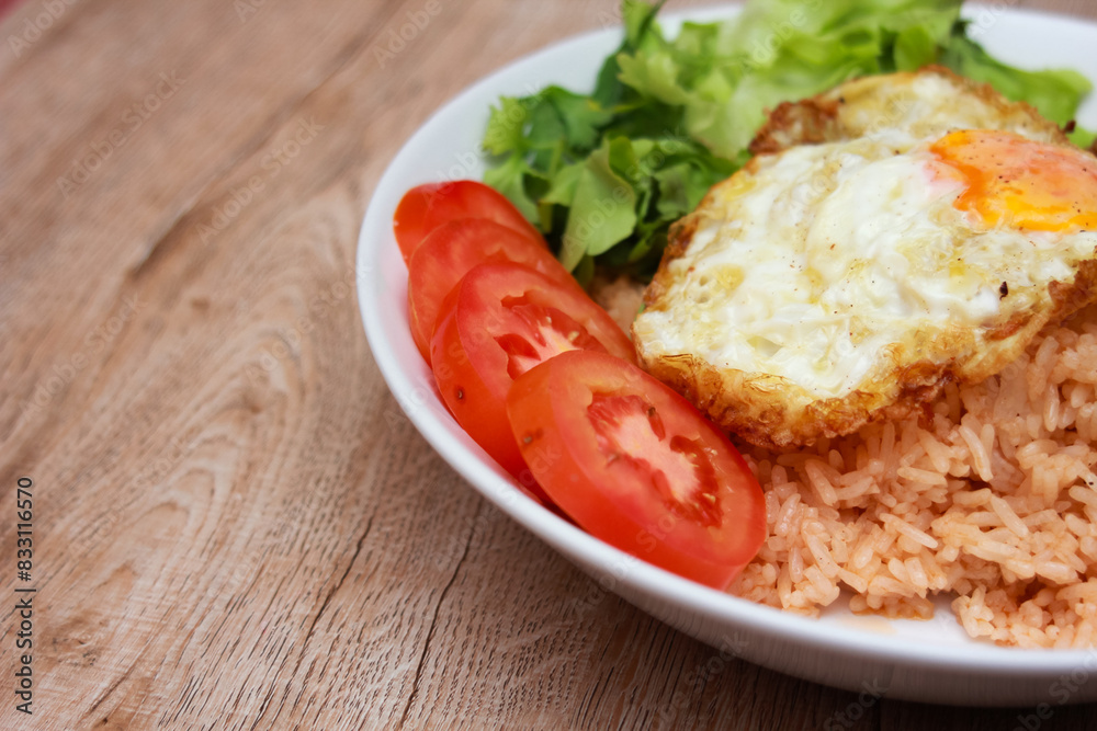 Fried rice with tomato sauce Or as we call it American fried rice Served with fried eggs, fried chicken, fresh stir-fry, and fried bread. Fried rice with tomato sauce Or as we call it American fried rice Served with fried eggs, fried chicken, fresh stir-fry, and fried bread.