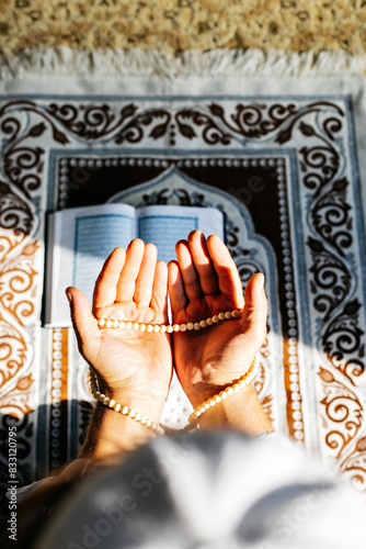 Close up of praying hands. 
Religious man doing muslim prayer on prayer mat in a mosque