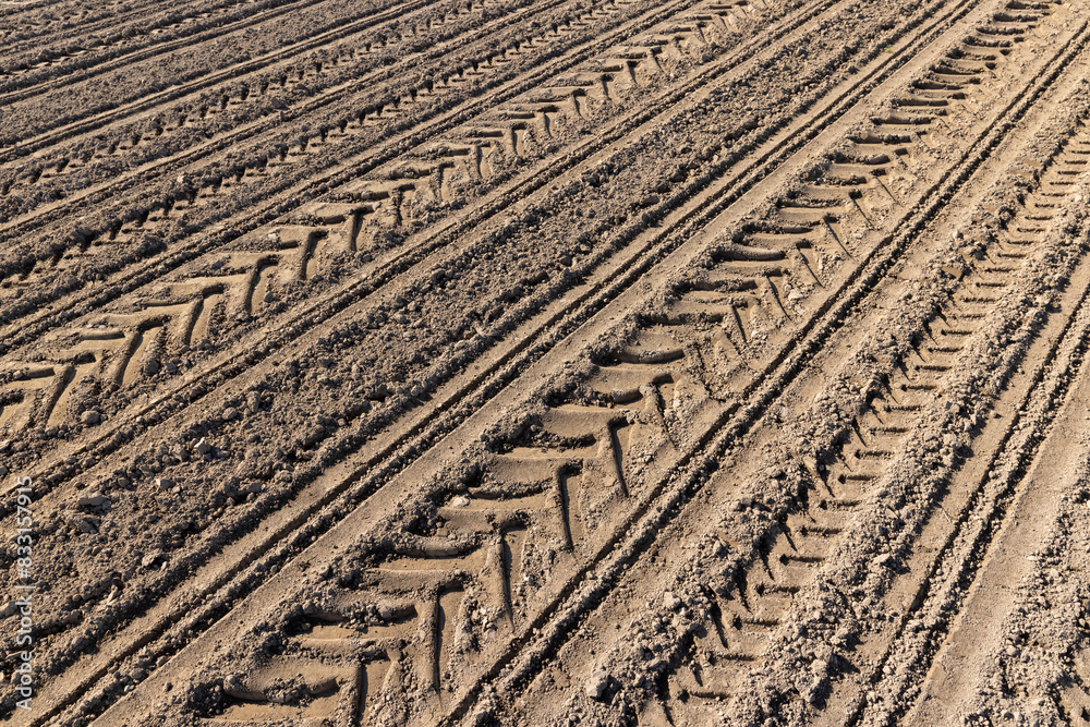 a plowed agricultural field with traces of a tractor a plowed agricultural field with traces of a tractor