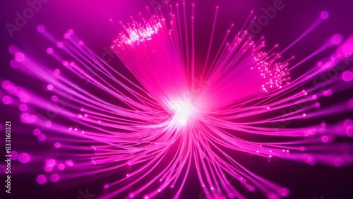 Vibrant pink fiber optic lights radiating from a central point, creating an abstract, futuristic feel. The glowing strands spread outwards, evoking a sense of energy and connectivity.

