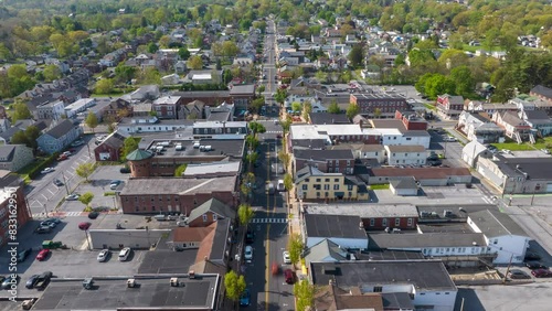 Small American town in spring. Aerial hyperlapse over busy main street traffic. Historic, quaint buildings and square. photo