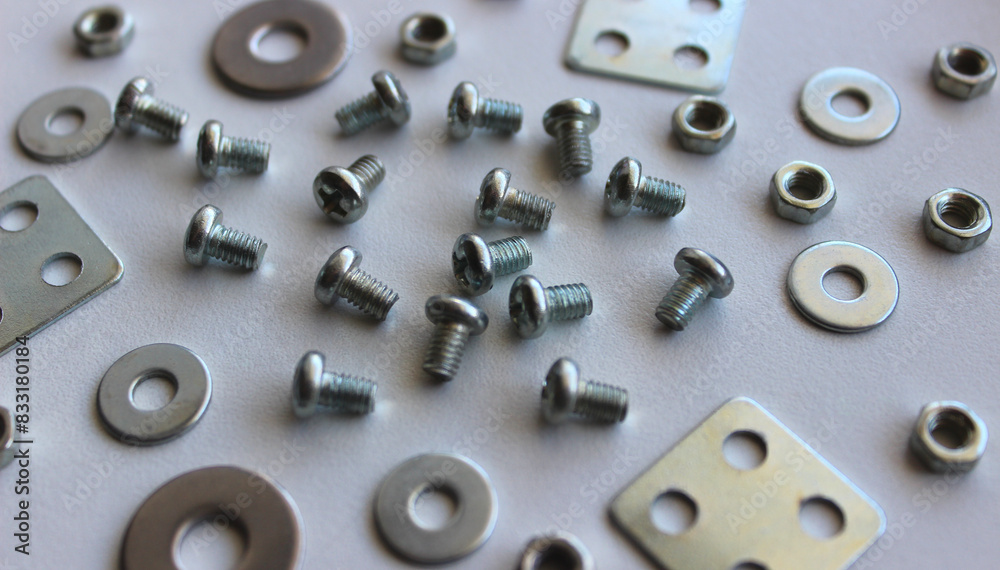 Macro photo of scattered washers, spacers, nuts and bolts on the white plastic sheet. Stock Photo For Fastener Hardware Backgrounds
Macro photo of scattered washers, spacers, nuts and bolts on the white plastic sheet. Stock Photo For Fastener Hardware Backgrounds