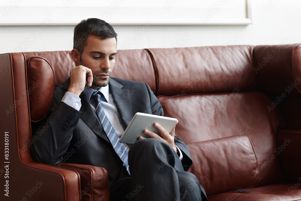 Reading, tablet and businessman on couch for online, research and email in waiting room. Trader, stock market and internet with technology for planning and proposal for startup company in New York Reading, tablet and businessman on couch for online, research and email in waiting room. Trader, stock market and internet with technology for planning and proposal for startup company in New York