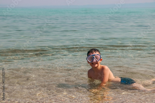 Child with swimming mask in the sea