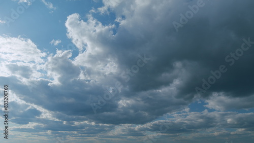 Tropical summer sunlight. Blue sky with stratus and stratocumulus clouds. Fluffy layered clouds sky atmosphere. Timelapse. photo