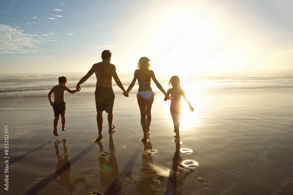 Fototapeta premium Family, beach and holding hands in sunset for holiday, vacation and summer together. Back of parents, people and children in swimwear by ocean and sunshine for support, love and security or travel