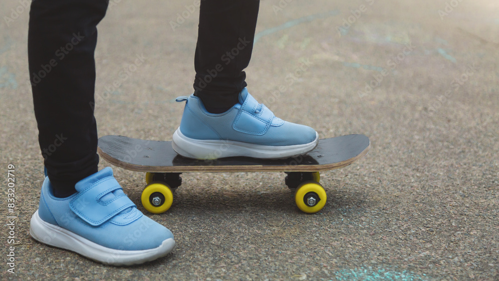 Freedom and happiness. Happy child girl riding her longboard on an empty sunny road, laughing and smiling, skateboarding.