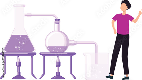 The boy stands near the experimental equipment.