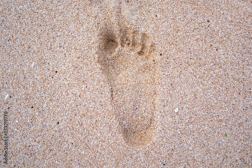 Child-sized human footprints in the beach sand.