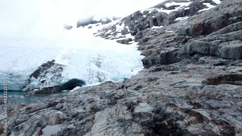 Drone revealing people walking up to Brewster Glacier at Brewster Track in Mount Aspiring National Park, New Zealand. Drone revealing people walking up to Brewster Glacier at Brewster Track in Mount Aspiring National Park, New Zealand.