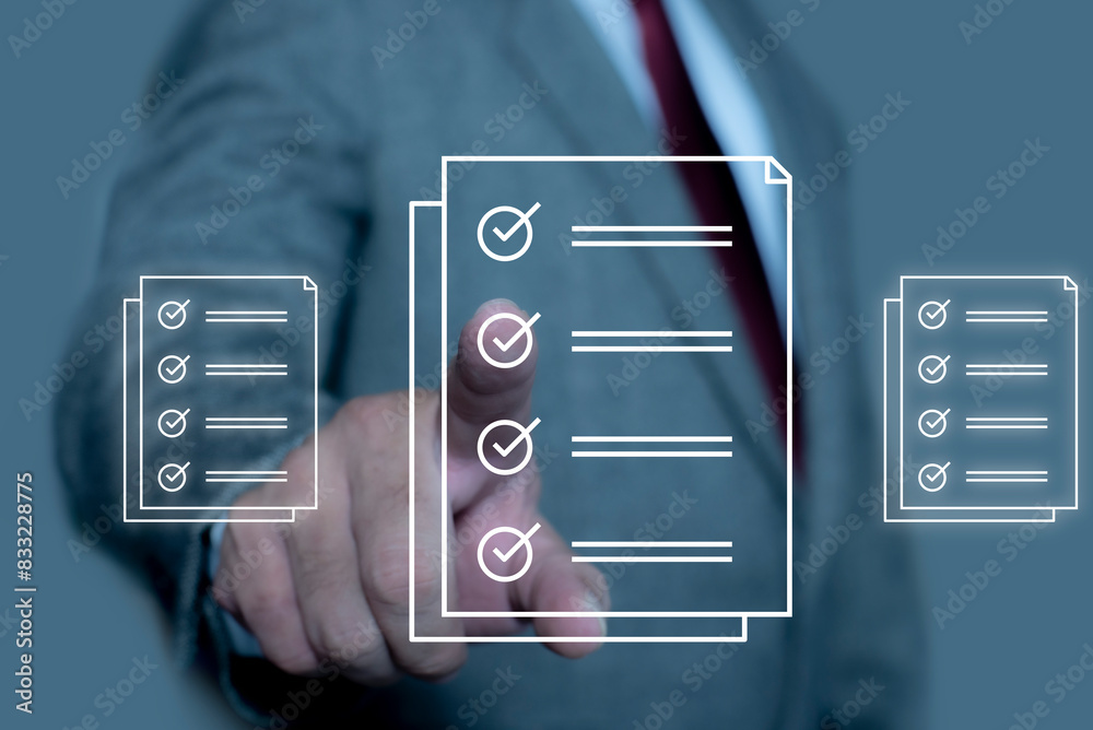 Obraz premium Businessman check and check mark on document online. Businessman tick off questionnaire, Business Agreements and Approvals, Digital checklist option. Check list concept.