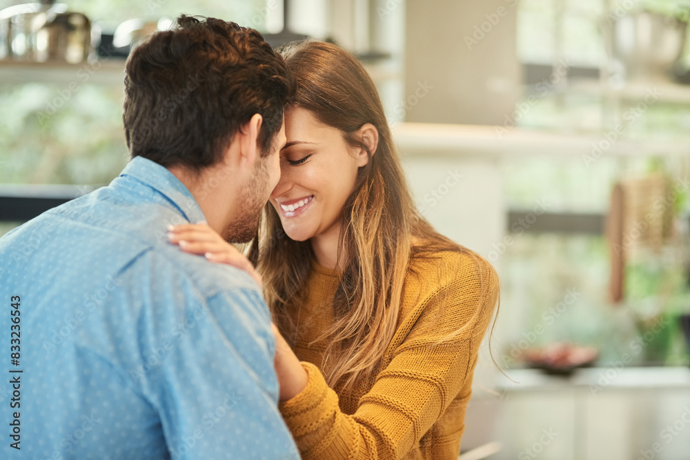 Love, bonding and couple hugging in kitchen in morning for greeting, support and care at home. Happy, romance and young man and woman embracing for sweet moment together at modern apartment in Canada Love, bonding and couple hugging in kitchen in morning for greeting, support and care at home. Happy, romance and young man and woman embracing for sweet moment together at modern apartment in Canada