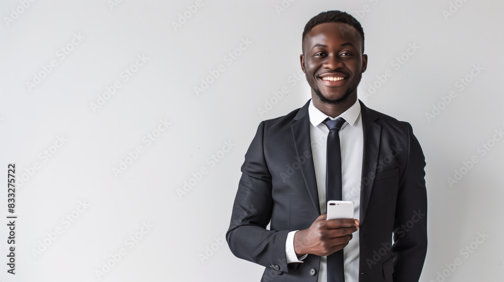 African corporate man standing confidently with a smartphone African corporate man standing confidently with a smartphone