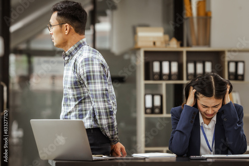 Young businesswoman and other Asian individuals are seen working at desks. Accountability, faultfinding, negligence, and other aspects of recruitment, staffing, and talent management being discussed.