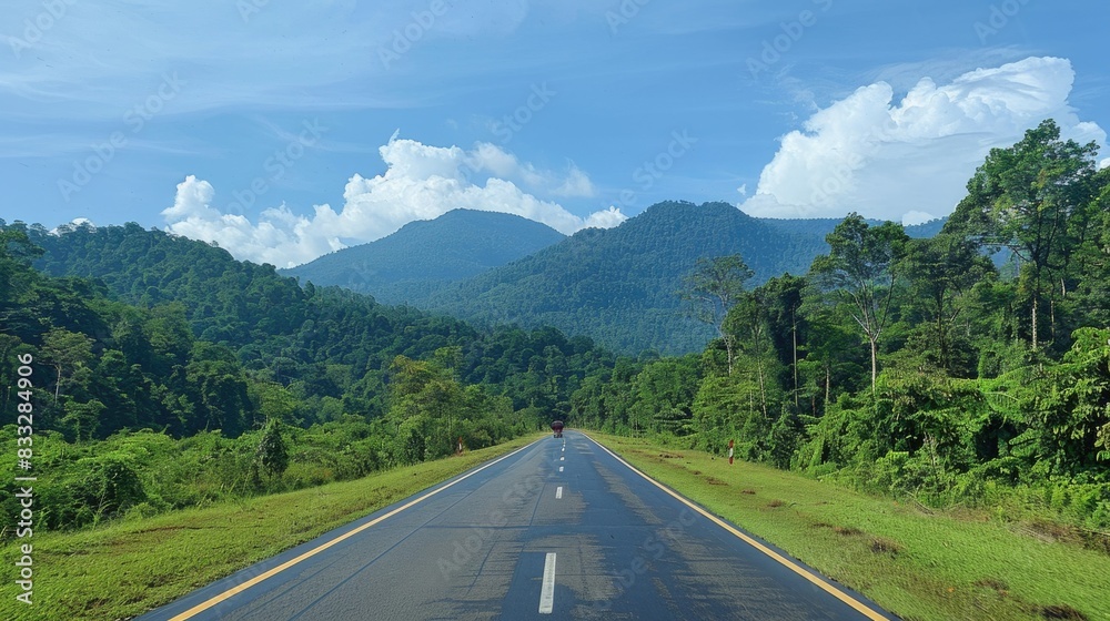 Empty road with mountains in background Empty road with mountains in background