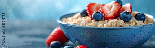 A bowl filled with oatmeal topped with fresh strawberries and blueberries. The concept of a healthy breakfast. photo