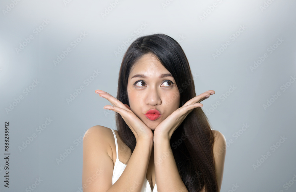 Thinking action on isolated with asian woman model look up on screen and touch her face for advertising Thinking action on isolated with asian woman model look up on screen and touch her face for advertising