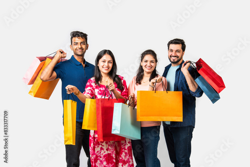 Indian asian young friends enjoying after shopping, showing colo