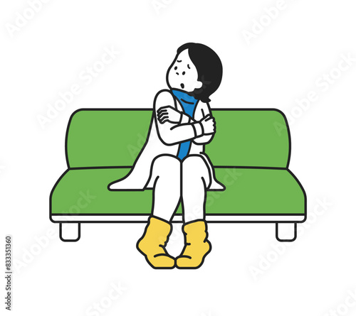 ソファで寒そうにしている女性