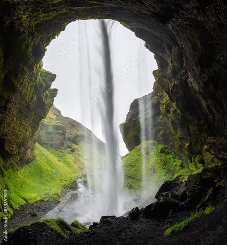 Scene from behind a hidden waterfall Kvernufoss in Iceland photo