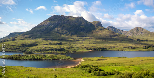 Views of Sgorr Tuath and Loch Lurgainn with Beinn an Eoin, Sgurr an Fhidhleir and Ben More Coigach behind in the Scottish Highlands on a sunny summers day in the UK photo