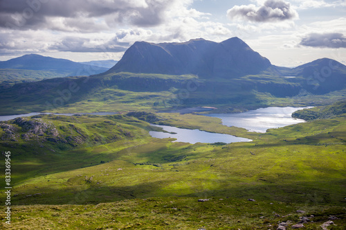 Obraz na płótnie Views of the summits of Cul Mor and An Laogh with Loch an Doire Dhuibh below from the summit of Stac Pollaidh in the Scottish Highlands on a sunny summers day with dramatic clouds in the UK w salonie