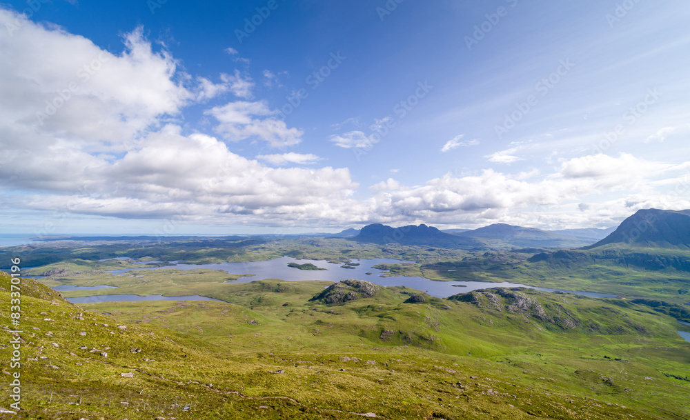 Views of the summits of Suilven and edge of Cul Mor with Loch Sionasgaig below from the summit of Stac Pollaidh in the Scottish Highlands on a sunny summers day in the UK Views of the summits of Suilven and edge of Cul Mor with Loch Sionasgaig below from the summit of Stac Pollaidh in the Scottish Highlands on a sunny summers day in the UK