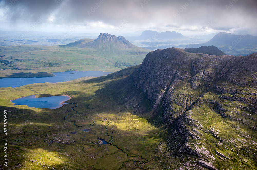 Views of Stac Pollaidh, Suilven and Cul Mor and Sgorr Tuath closest to the camera from the summit of Sgurr an Fhidhleir with Loch Lurgainn and Loch Dearg below in the Scottish Highlands in the UK.