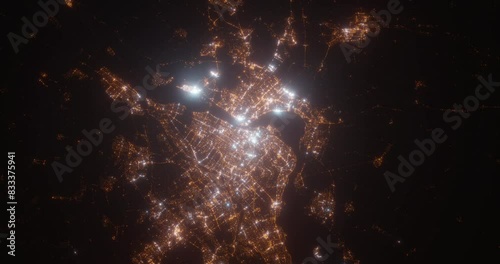 Montreal (Canada) aerial view at night. Top view on modern city with street lights. Camera is zooming out, rotating clockwise. Vertical video. The north is on the left side