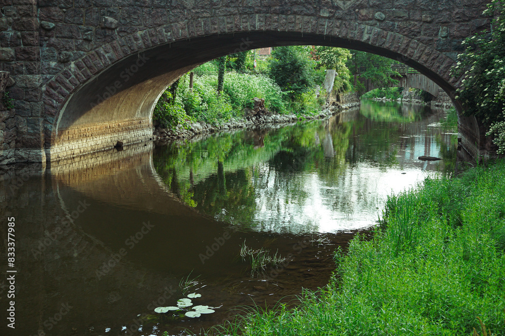 Fototapeta premium A beautiful stone bridge over a canal
