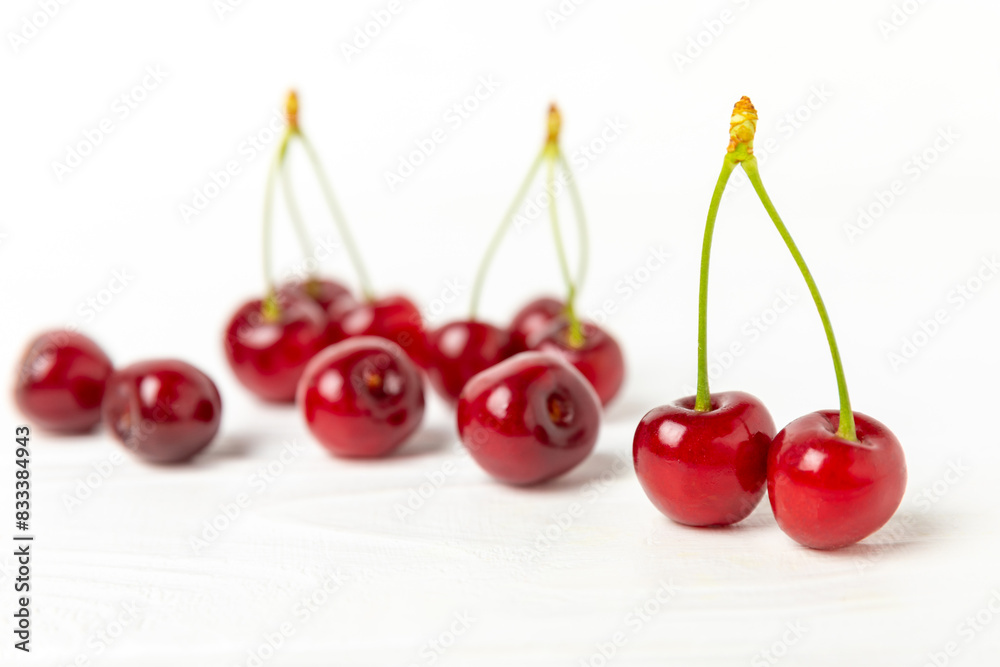 Cherries. Fresh ripe cherries with leaves on a textured wooden background. Fresh sweet organic cherry pile. Berries and fruits. Vegan. Healthy eating. Place for text. Copy space Cherries. Fresh ripe cherries with leaves on a textured wooden background. Fresh sweet organic cherry pile. Berries and fruits. Vegan. Healthy eating. Place for text. Copy space
