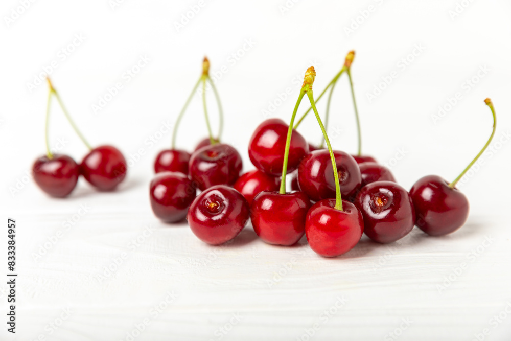 Cherries. Fresh ripe cherries with leaves on a textured wooden background. Fresh sweet organic cherry pile. Berries and fruits. Vegan. Healthy eating. Place for text. Copy space Cherries. Fresh ripe cherries with leaves on a textured wooden background. Fresh sweet organic cherry pile. Berries and fruits. Vegan. Healthy eating. Place for text. Copy space