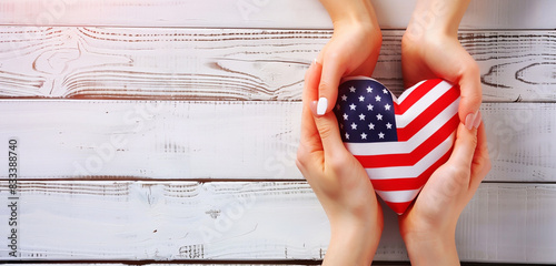 Symbolic female hands making a heart with a US flag, minimalist white Memorial Day theme. photo