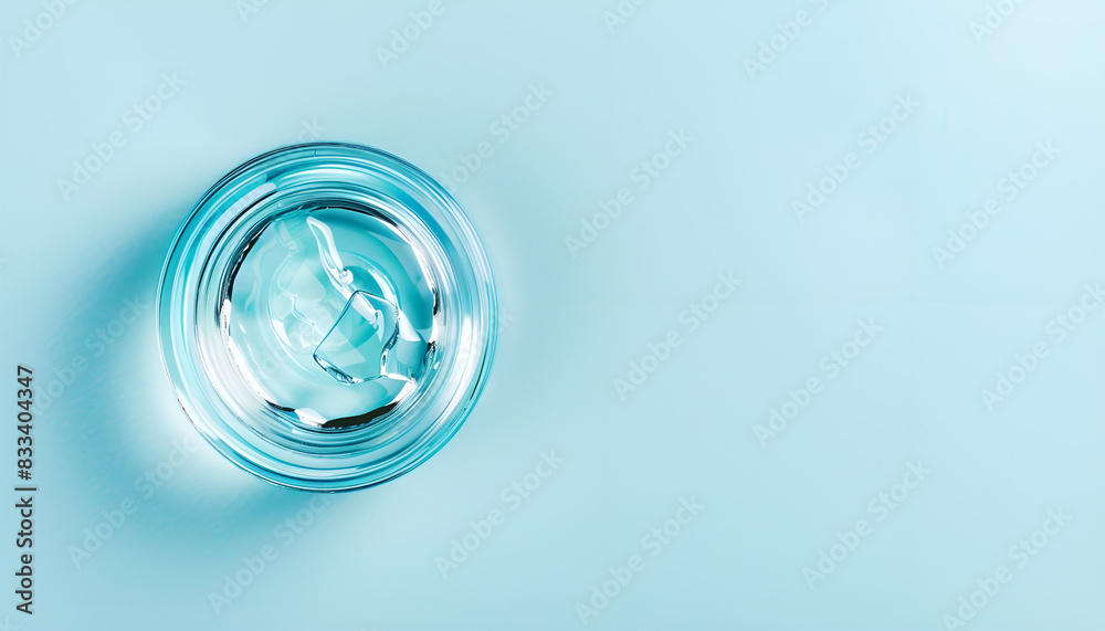 Clear cosmetic gel on light blue background, top view. Space for text Clear cosmetic gel on light blue background, top view. Space for text