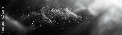 Abstract black and white image featuring a dynamic display of floating particles and light streaks, creating a mesmerizing and ethereal effect. photo