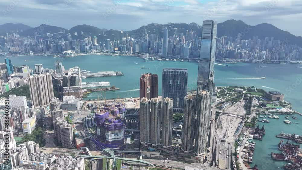Aerial shots capturing Hong Kong Kowloon Peninsula Tsim Sha Tsui harbourfront with Harbour City, iconic Victoria Harbour and  Central Admiralty Wan Chai skyline backdrop
