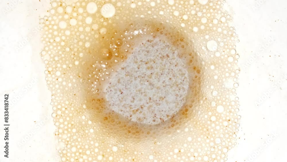 Close-up Effervescent tablet aspirin, vitamins on a white background. Macro shot of fine air bubbles in water in a petri dish. The medicine concept, health care, treatment. Slow motion. 4k Close-up Effervescent tablet aspirin, vitamins on a white background. Macro shot of fine air bubbles in water in a petri dish. The medicine concept, health care, treatment. Slow motion. 4k