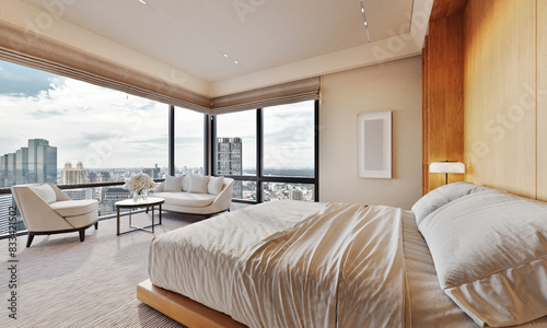 Modern and luxurious bedroom with white ceiling and wood accents with views of tall building and downtown Dubai skyline. Condo or Hotel