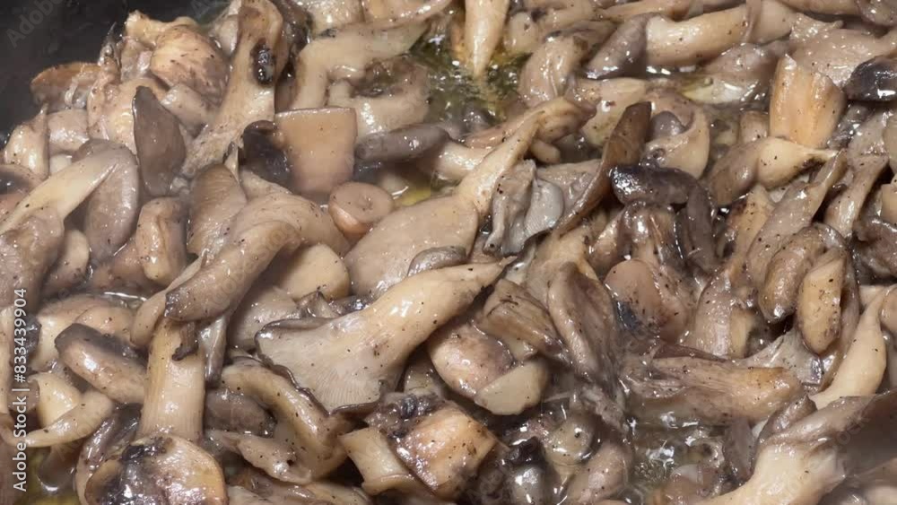 Oyster mushrooms in frying pan at the frying on cooking oil Oyster mushrooms in frying pan at the frying on cooking oil