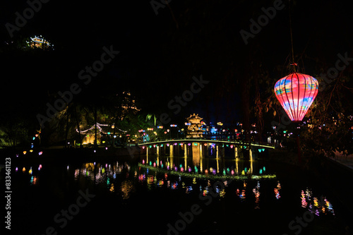 Illuminated Bridge at Night with Water Reflections, Ninh Binh, Vietnam photo