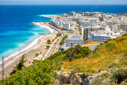 Aegean beach with sunshades in city of Rhodes (Rhodes, Greece)